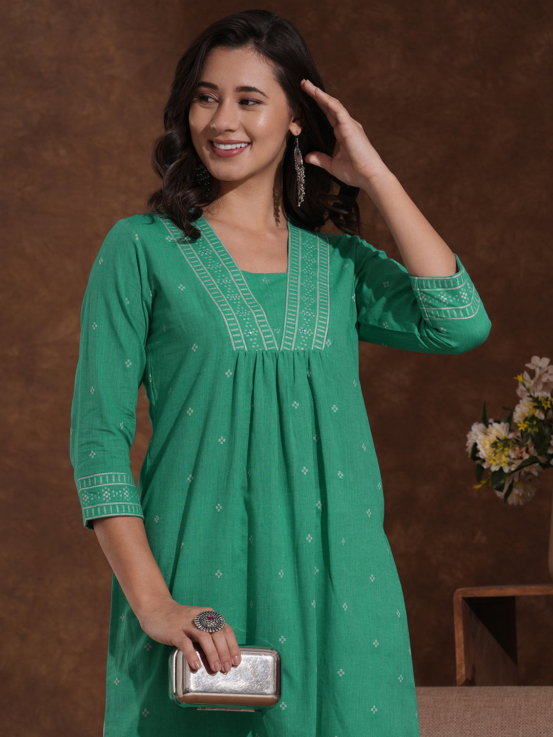 Straight kurta with border detailing on the neck and sleeves with mirrorwork.