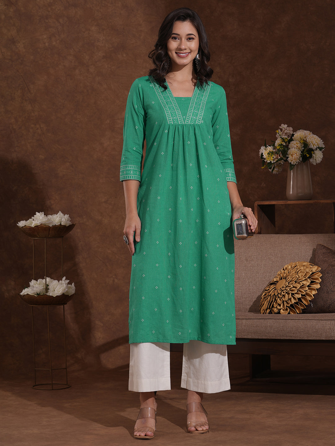 Straight kurta with border detailing on the neck and sleeves with mirrorwork.