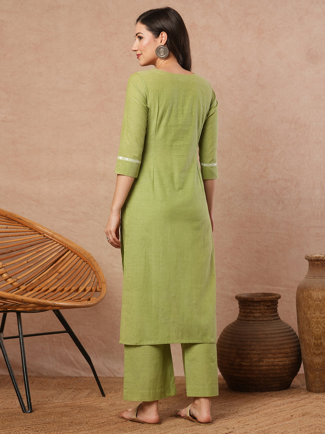 Straight kurta with machine applique around the placket.