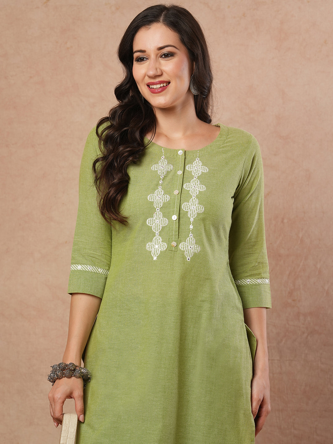 Straight kurta with machine applique around the placket.