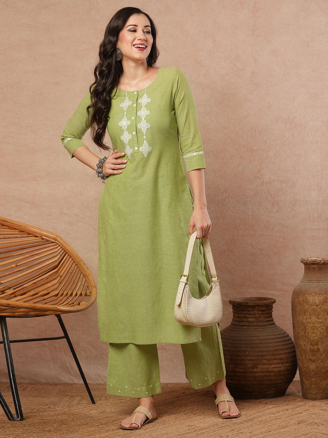 Straight kurta with machine applique around the placket.