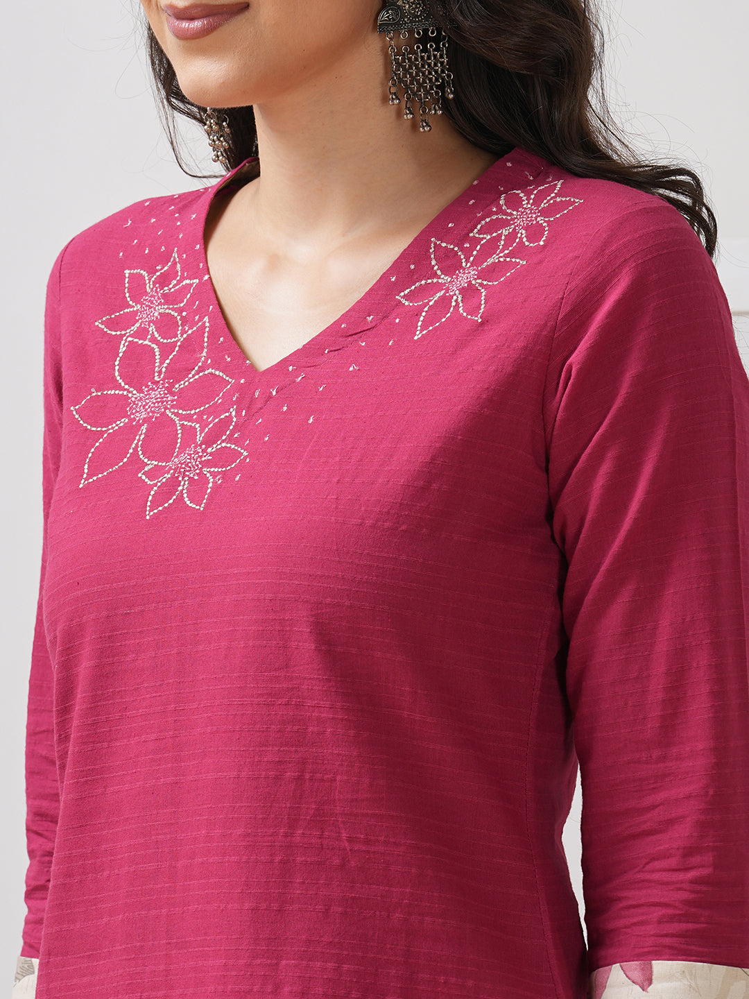 Straight fit kurta with embroidered neckline and contrast print roll-up cuff.