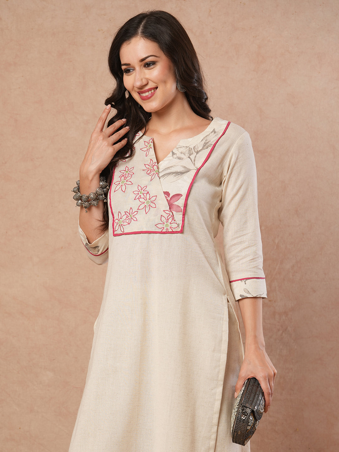 Straight fit solid kurta with a wrap half embroidered and half printed yoke.