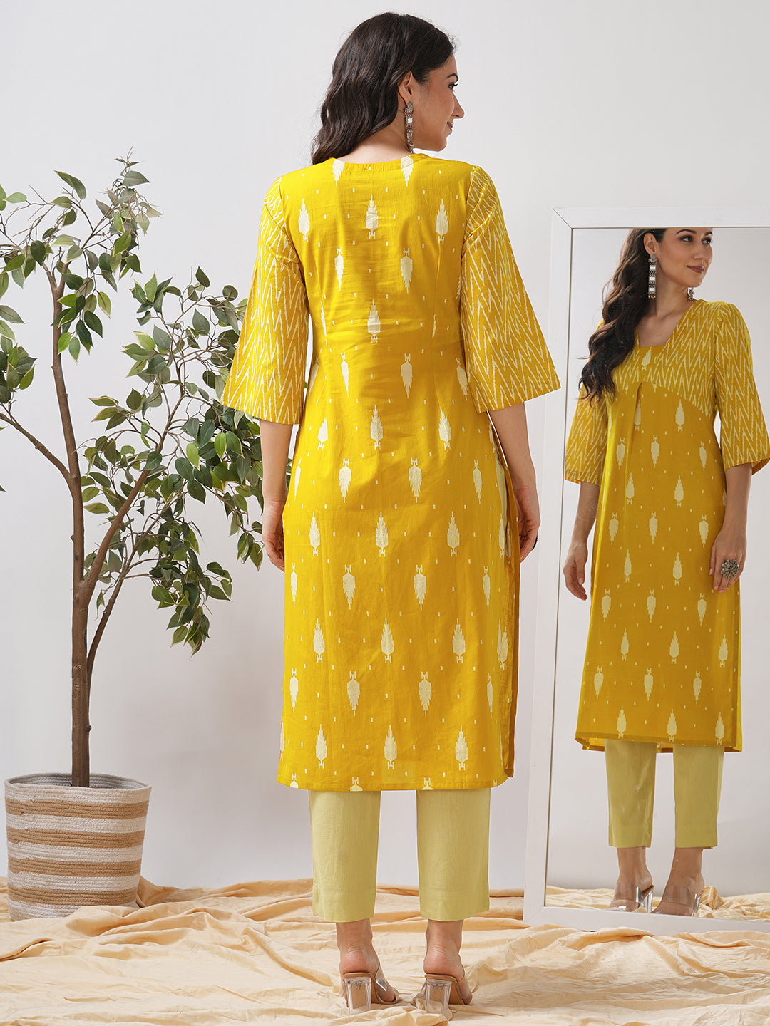 Straight fit shaped waist kurta with coordinated print yoke and bell sleeves.