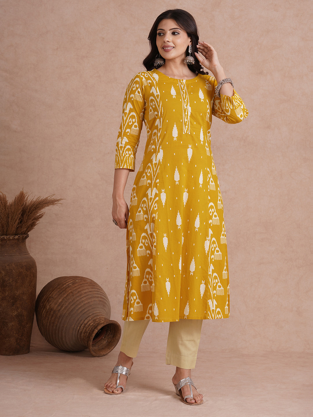 A-Line shoulder princess kurta with coordinating prints and handwork around placket.