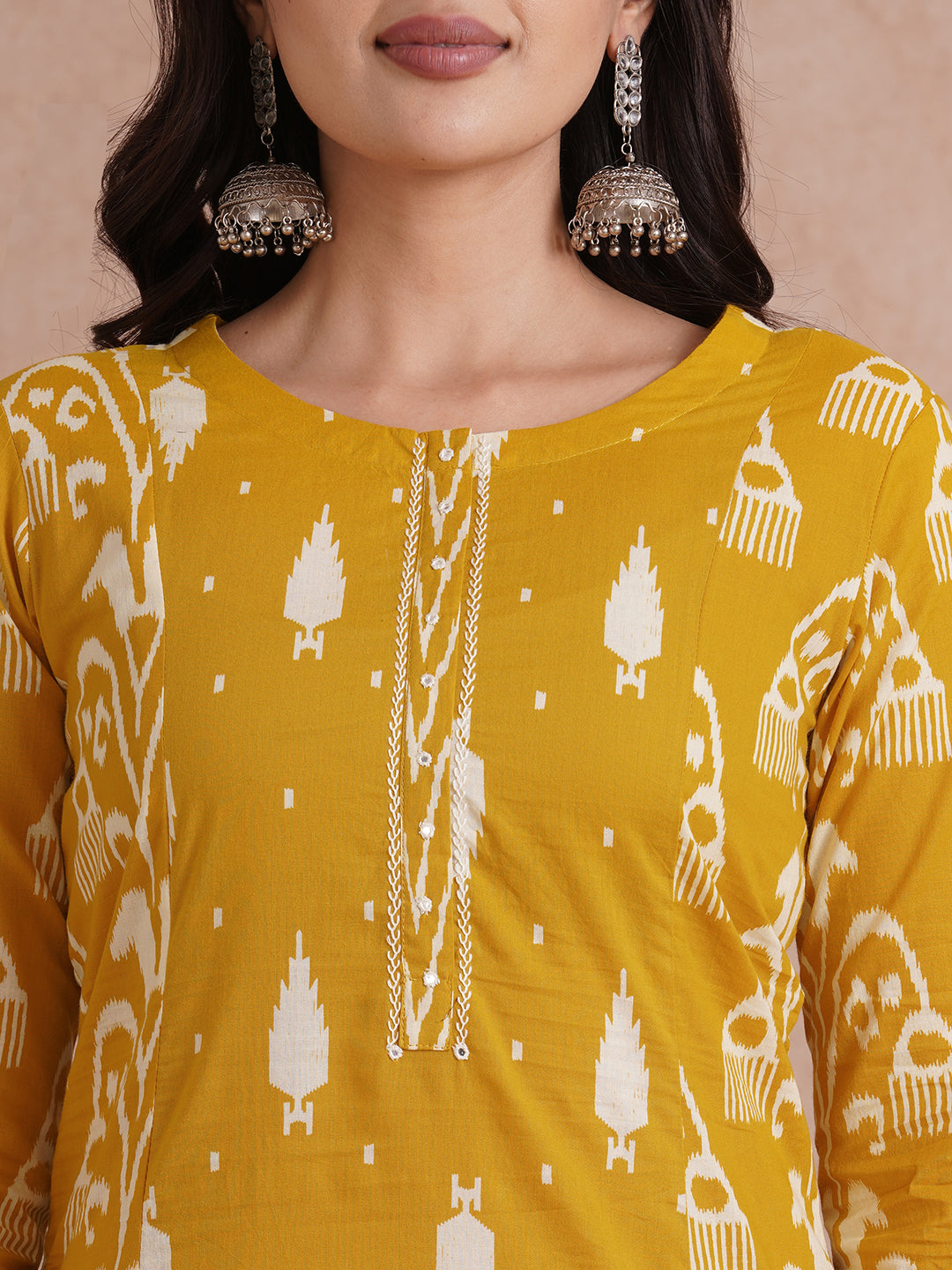 A-Line shoulder princess kurta with coordinating prints and handwork around placket.