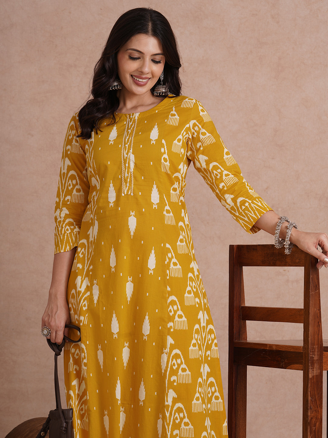 A-Line shoulder princess kurta with coordinating prints and handwork around placket.