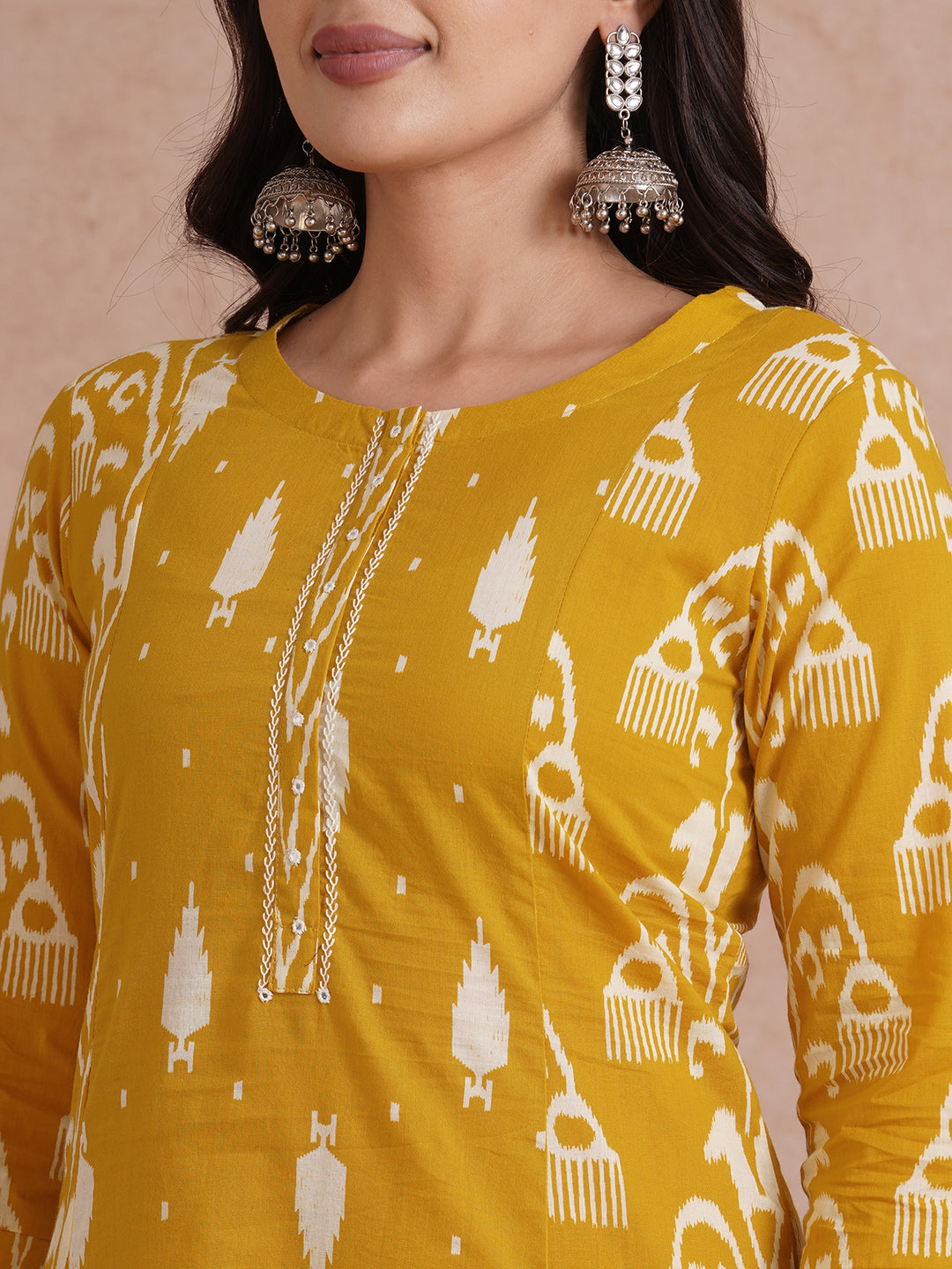 A-Line shoulder princess kurta with coordinating prints and handwork around placket.