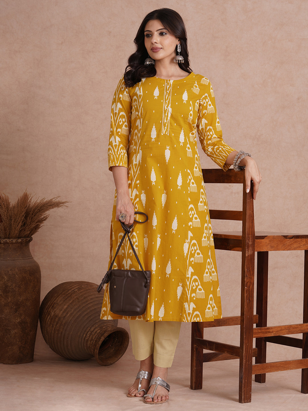 A-Line shoulder princess kurta with coordinating prints and handwork around placket.