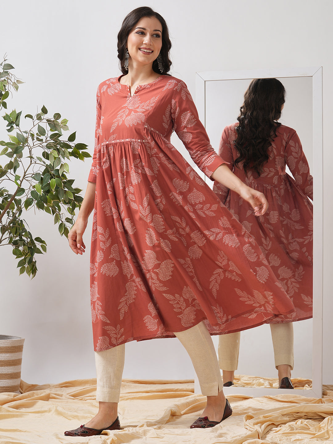 Printed flared kurta with layered waist gathers and trim detailing with handwork mirrors.