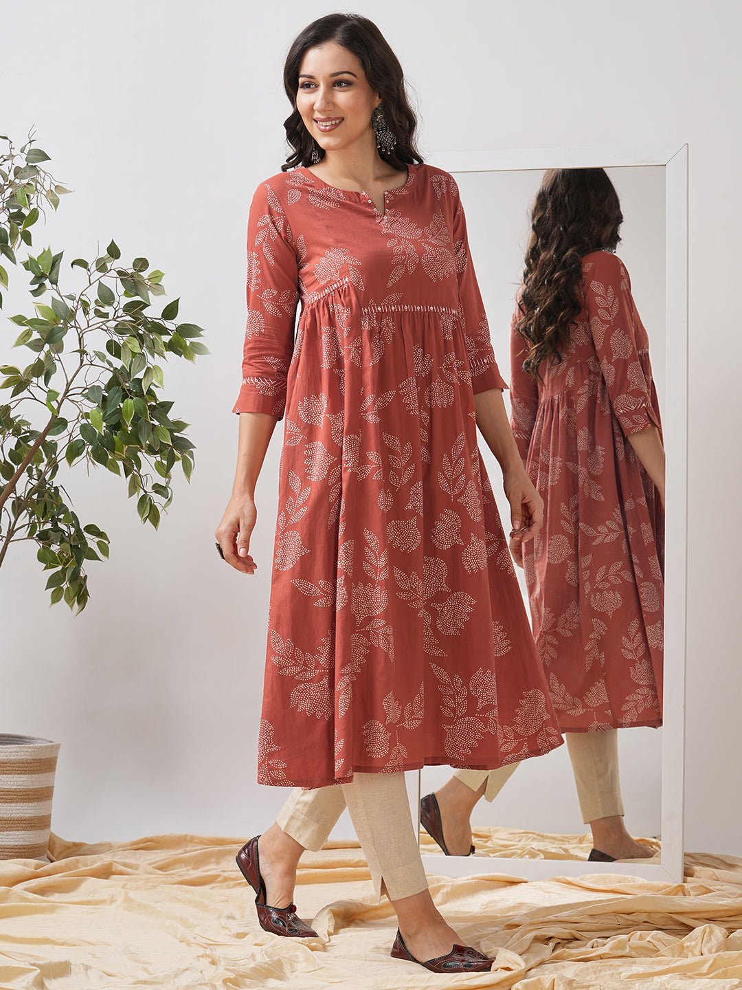 Printed flared kurta with layered waist gathers and trim detailing with handwork mirrors.