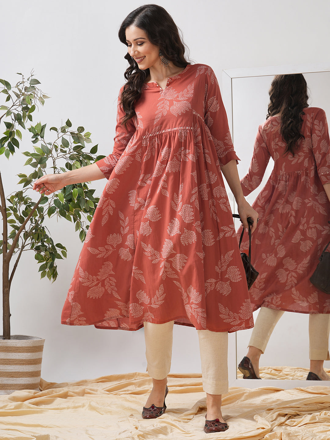 Printed flared kurta with layered waist gathers and trim detailing with handwork mirrors.