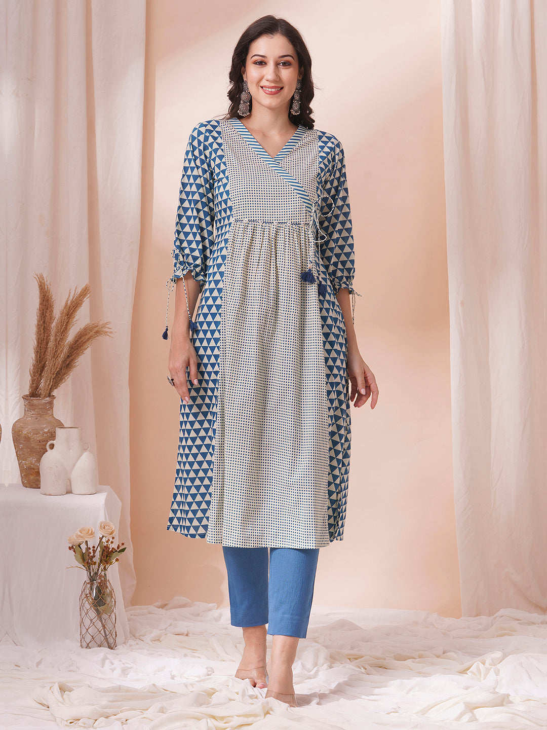 Gathered A-line kurta with overlapping yoke and gathered tie-up sleeves.
