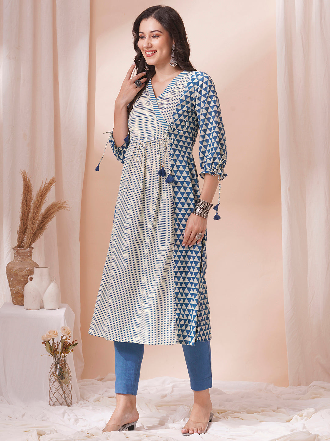 Gathered A-line kurta with overlapping yoke and gathered tie-up sleeves.