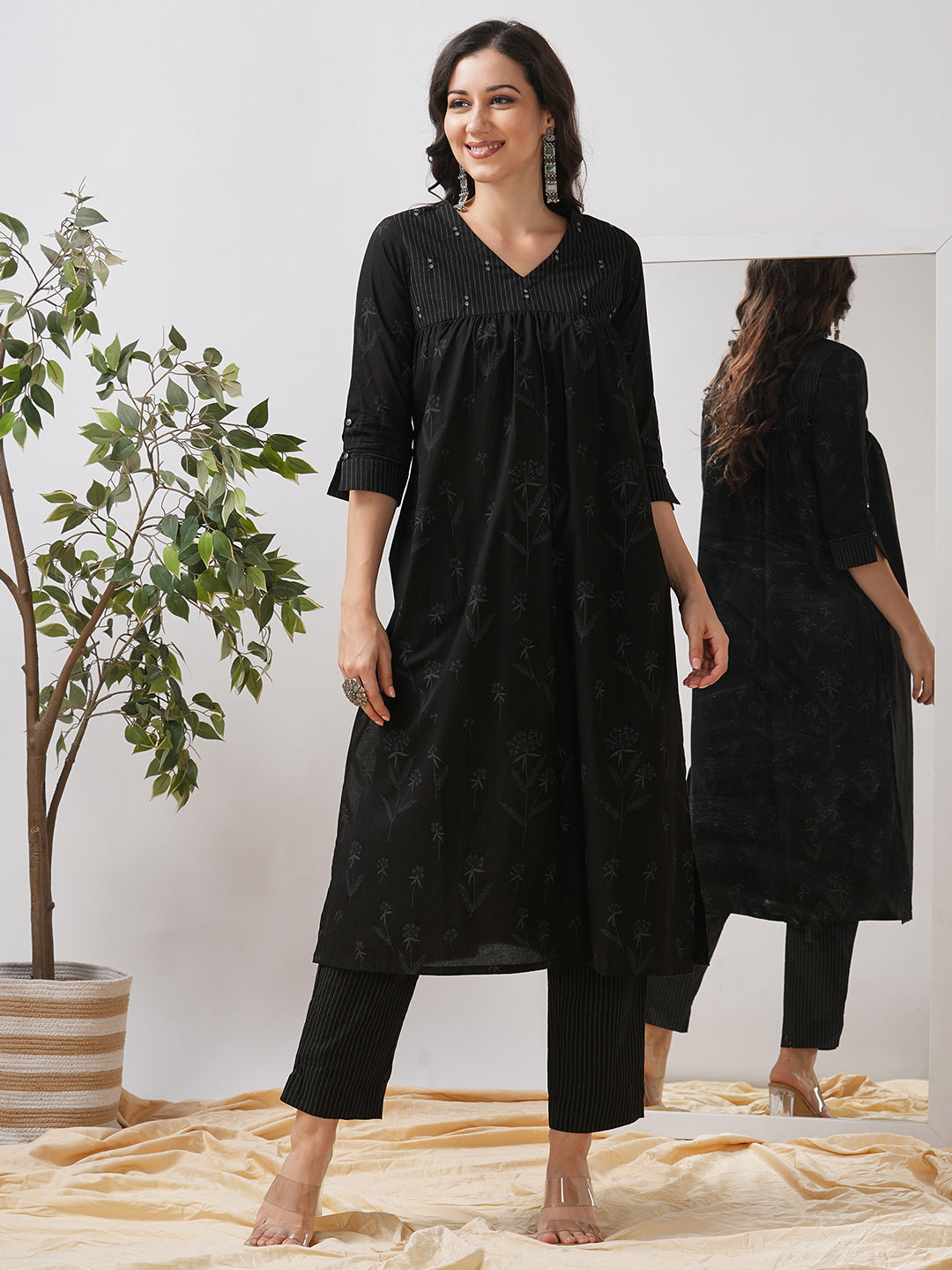 A gathered kurta with mirrorwork shoulder yoke and cuffed sleeves.
