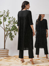 A gathered kurta with mirrorwork shoulder yoke and cuffed sleeves.