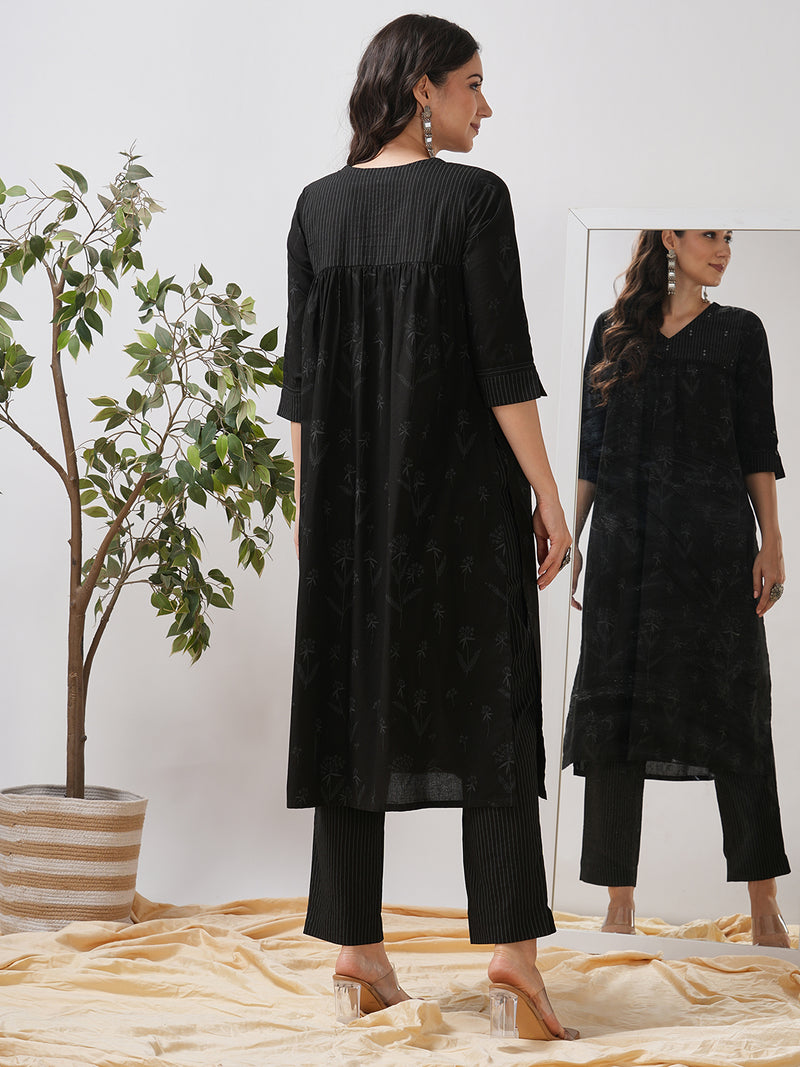 A gathered kurta with mirrorwork shoulder yoke and cuffed sleeves.