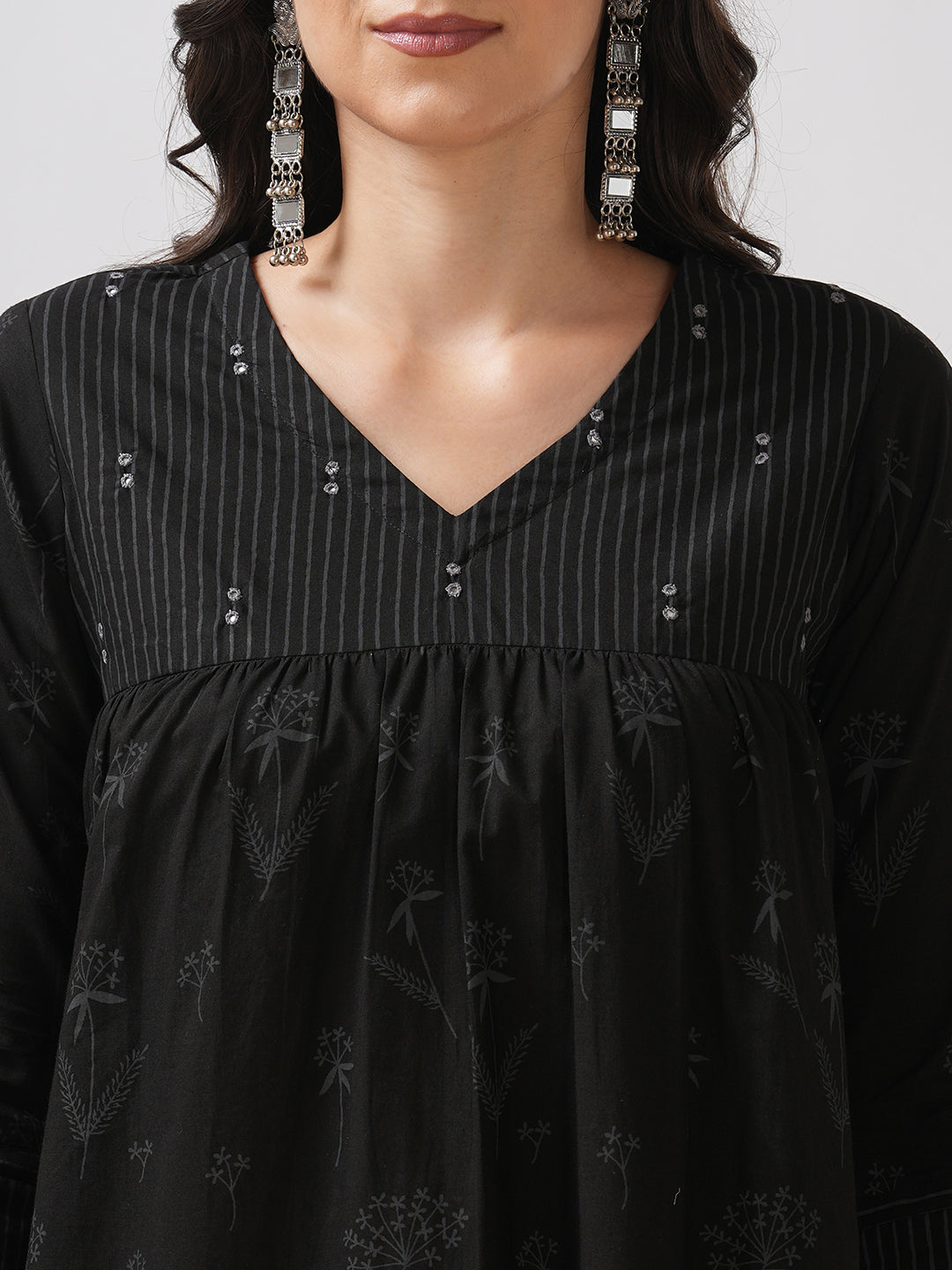 A gathered kurta with mirrorwork shoulder yoke and cuffed sleeves.