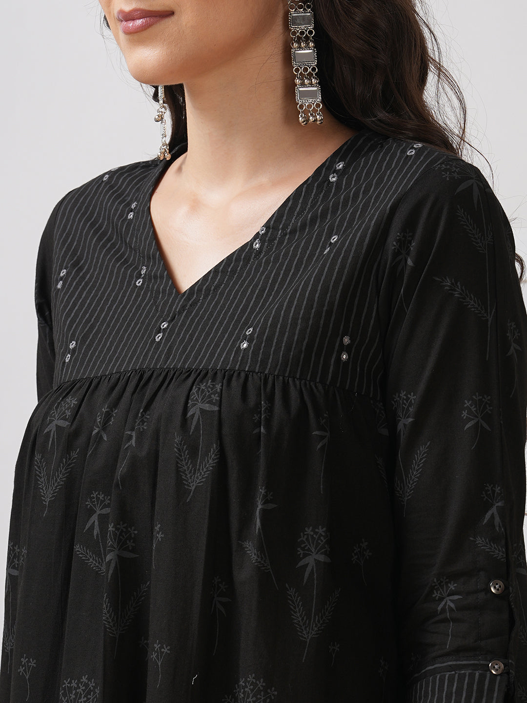 A gathered kurta with mirrorwork shoulder yoke and cuffed sleeves.