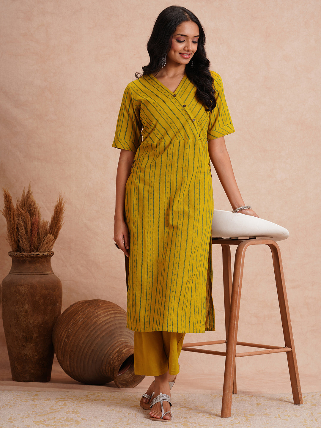 Straight fit kurta set with half sleeves and button detailing paired with plain palazzo.