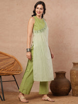 Sleeveless straight kurta with cutwork neckline and mirror work paired with palazzo.