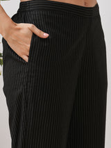 A gathered kurta set with mirrorwork shoulder yoke and cuffed sleeves paired with pant.
