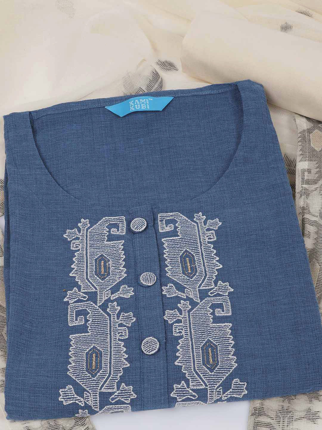 3-piece unstitched set features a blue embroidered top paired with a soft cream dupatta showcasing subtle woven motifs.