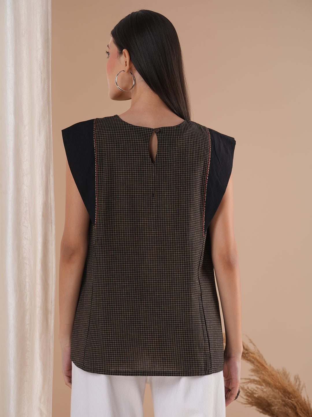 Black flared top in chequered cotton fabric with hand embroidered running stitch