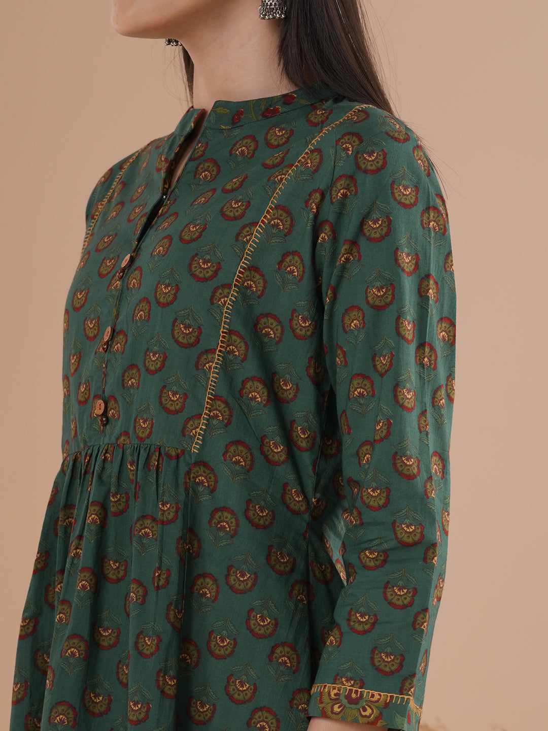 Gathered tunic in cotton print with hand embroidered feather stitch