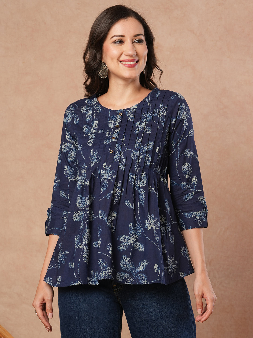 Pleated cotton print top with loop and button detailing on sleeve.