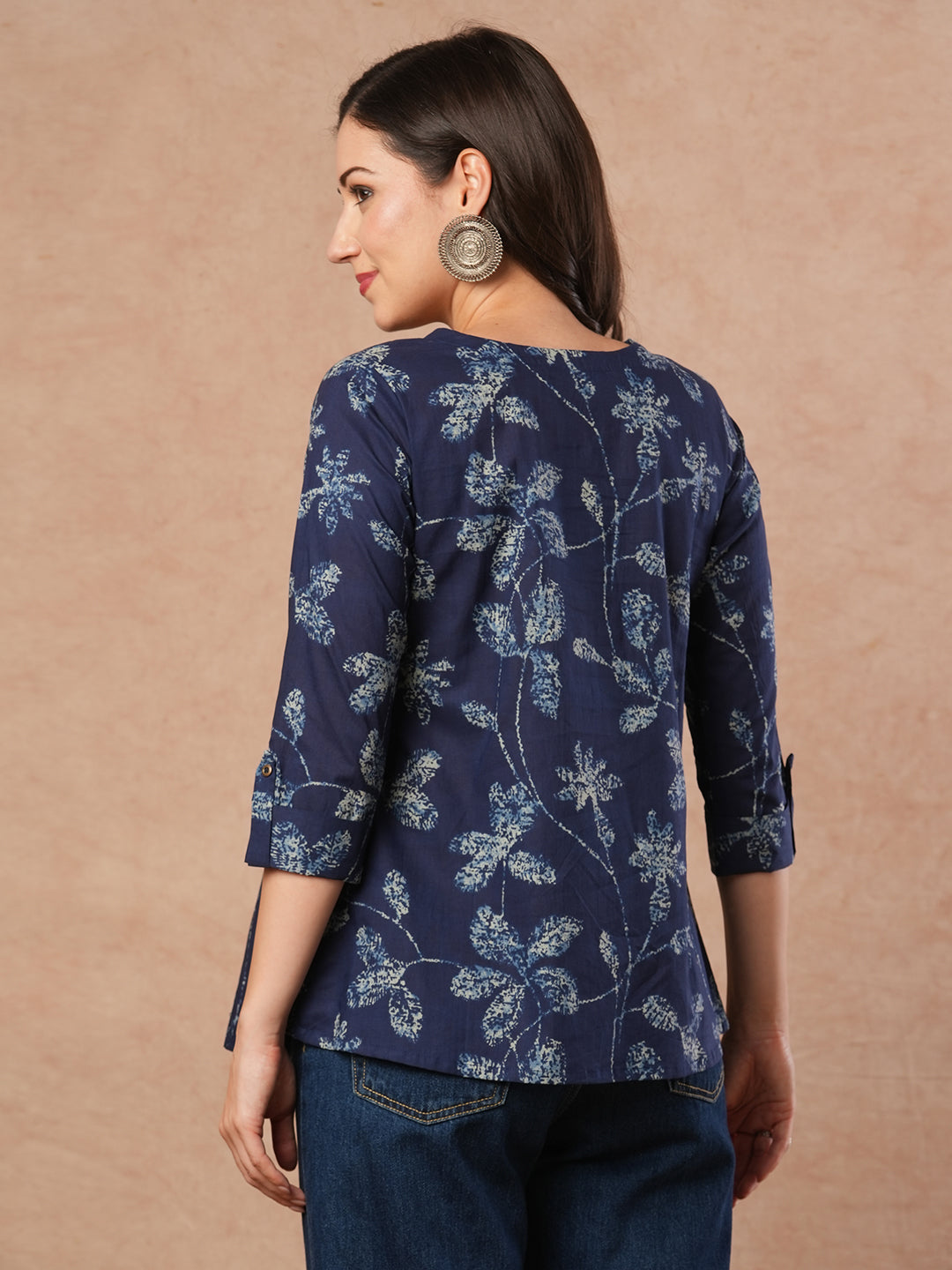 Pleated cotton print top with loop and button detailing on sleeve.