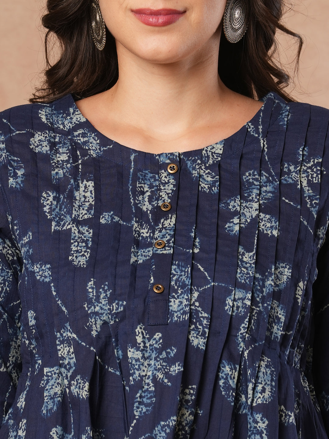 Pleated cotton print top with loop and button detailing on sleeve.