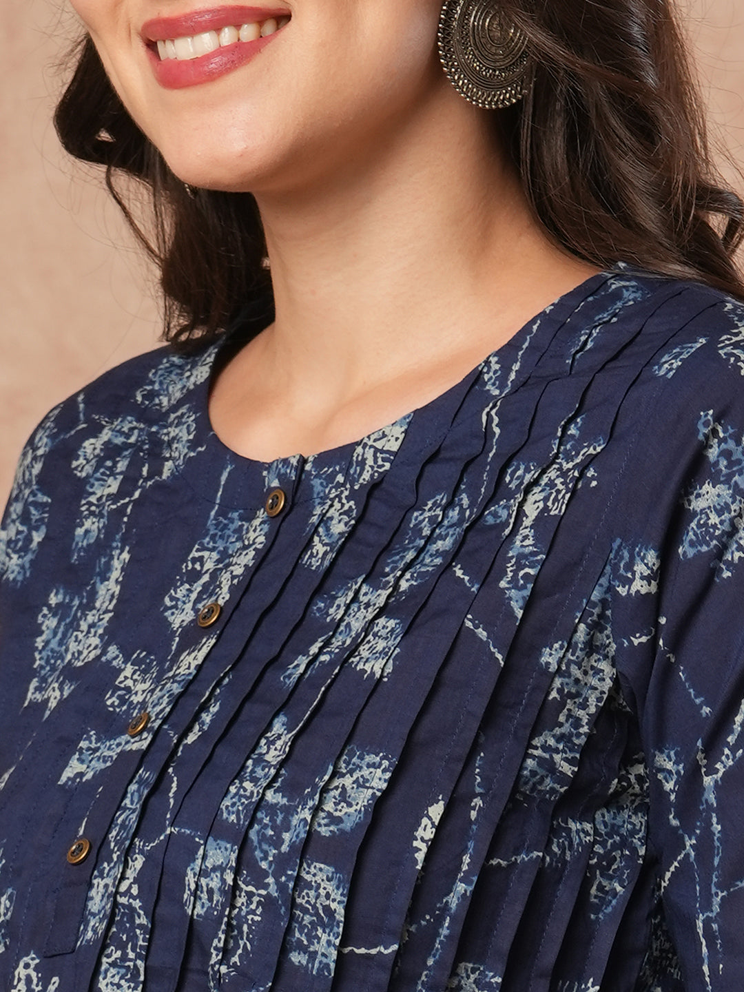 Pleated cotton print top with loop and button detailing on sleeve.