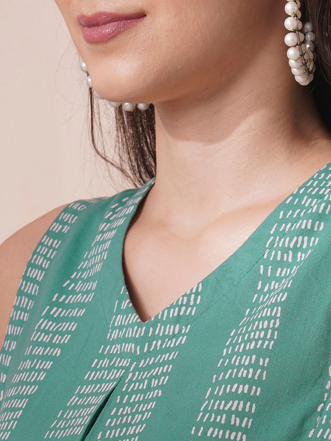 Printed flex sleeveless top with center pleat and elasticated gathers.