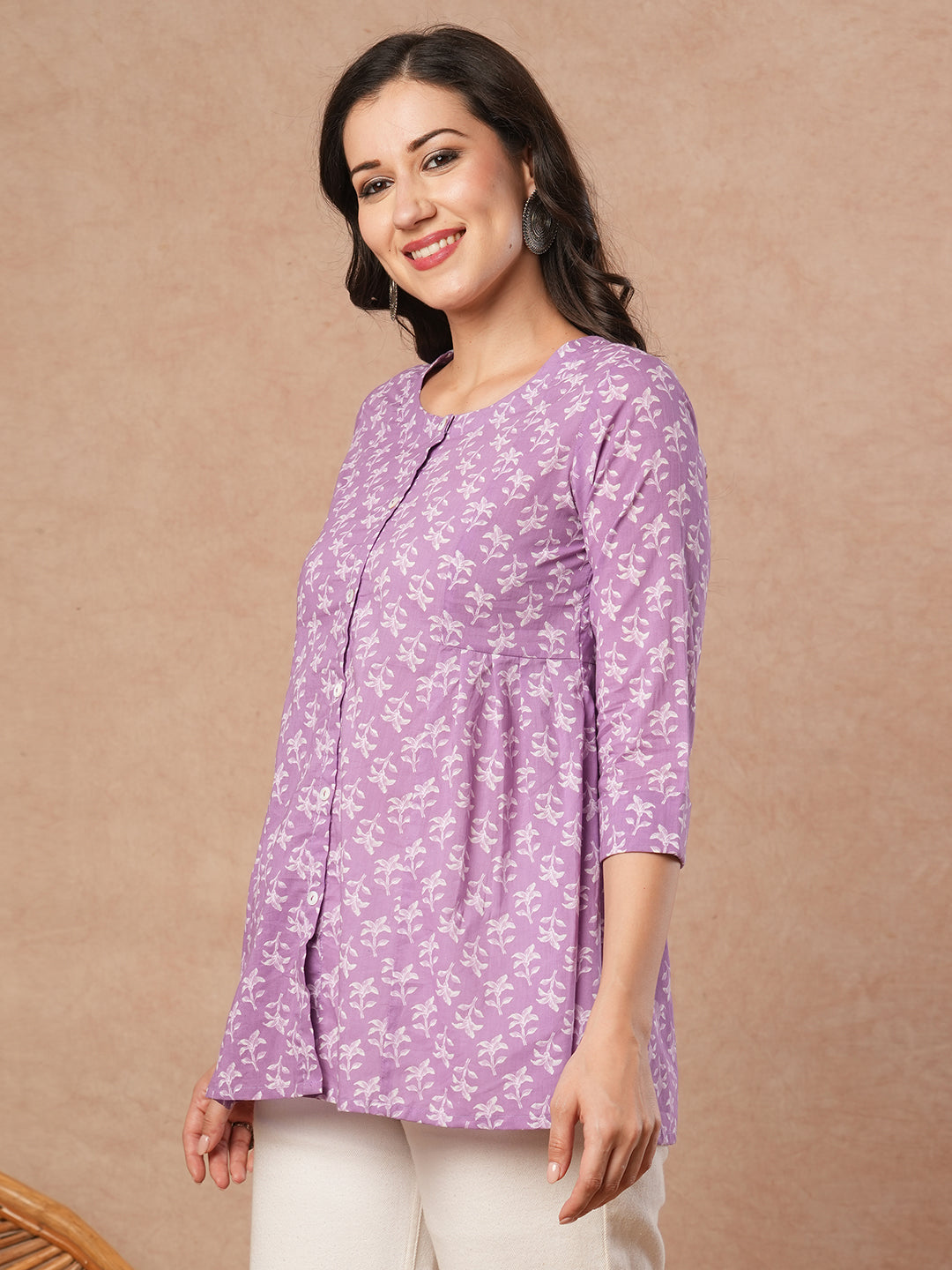 Printed top with centre button placket and pleated side panels.