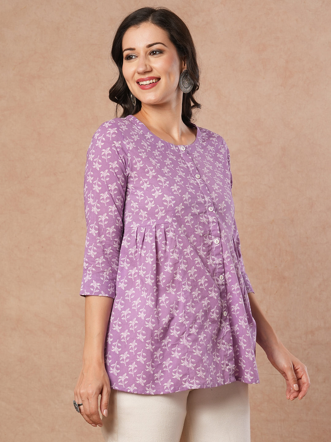 Printed top with centre button placket and pleated side panels.
