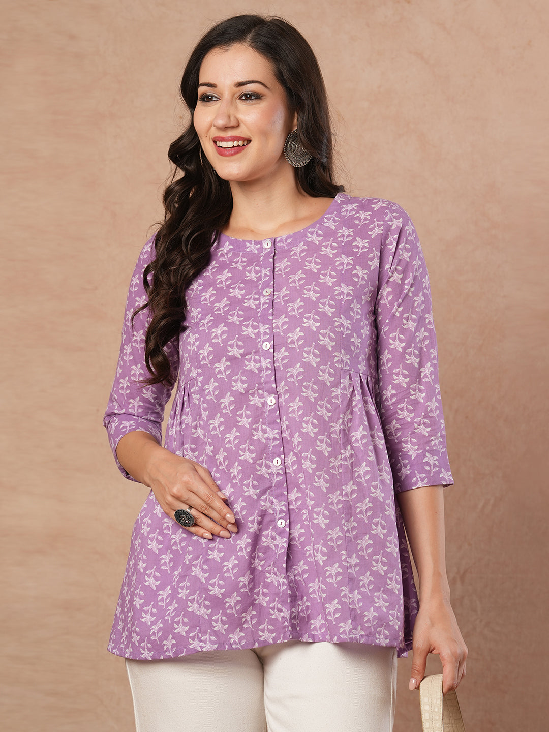 Printed top with centre button placket and pleated side panels.