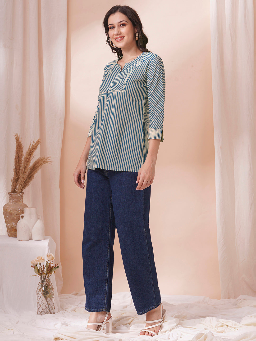 Striped top with mitered yoke and sleeves with polka border and cuff.