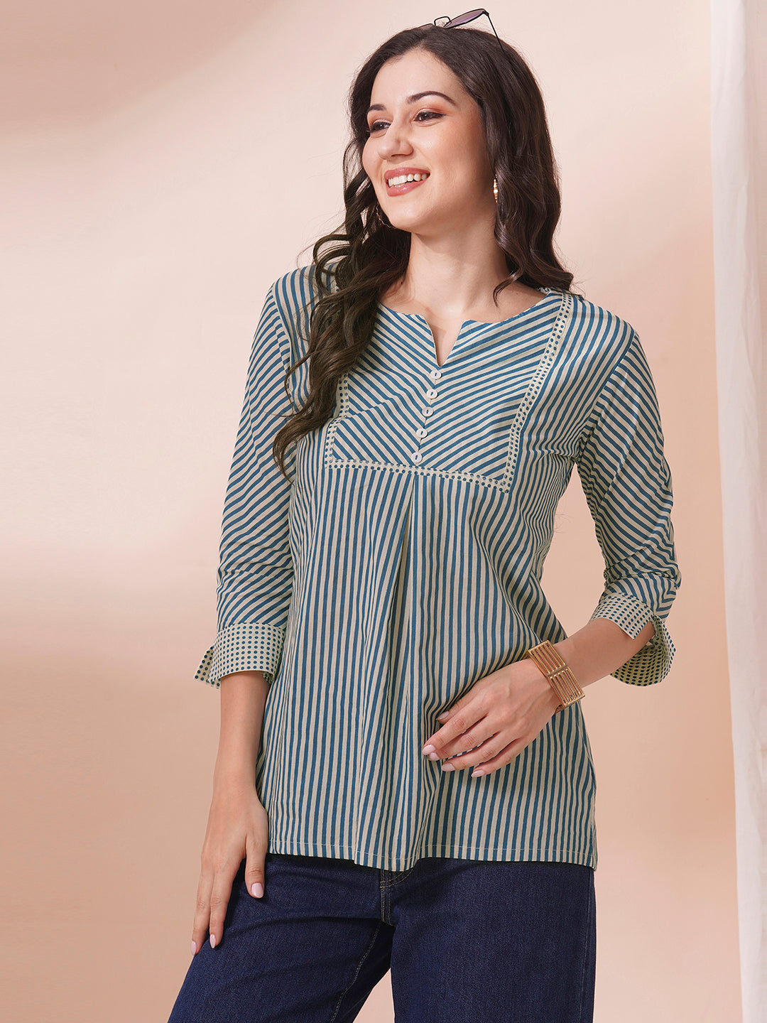 Striped top with mitered yoke and sleeves with polka border and cuff.