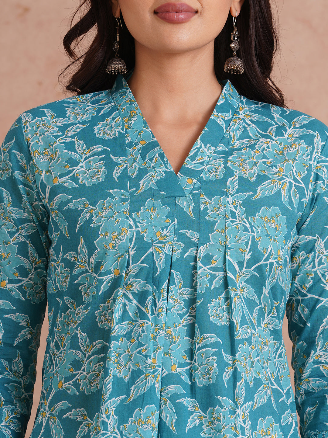 Printed top with knife pleat detailing and a V-neckline.