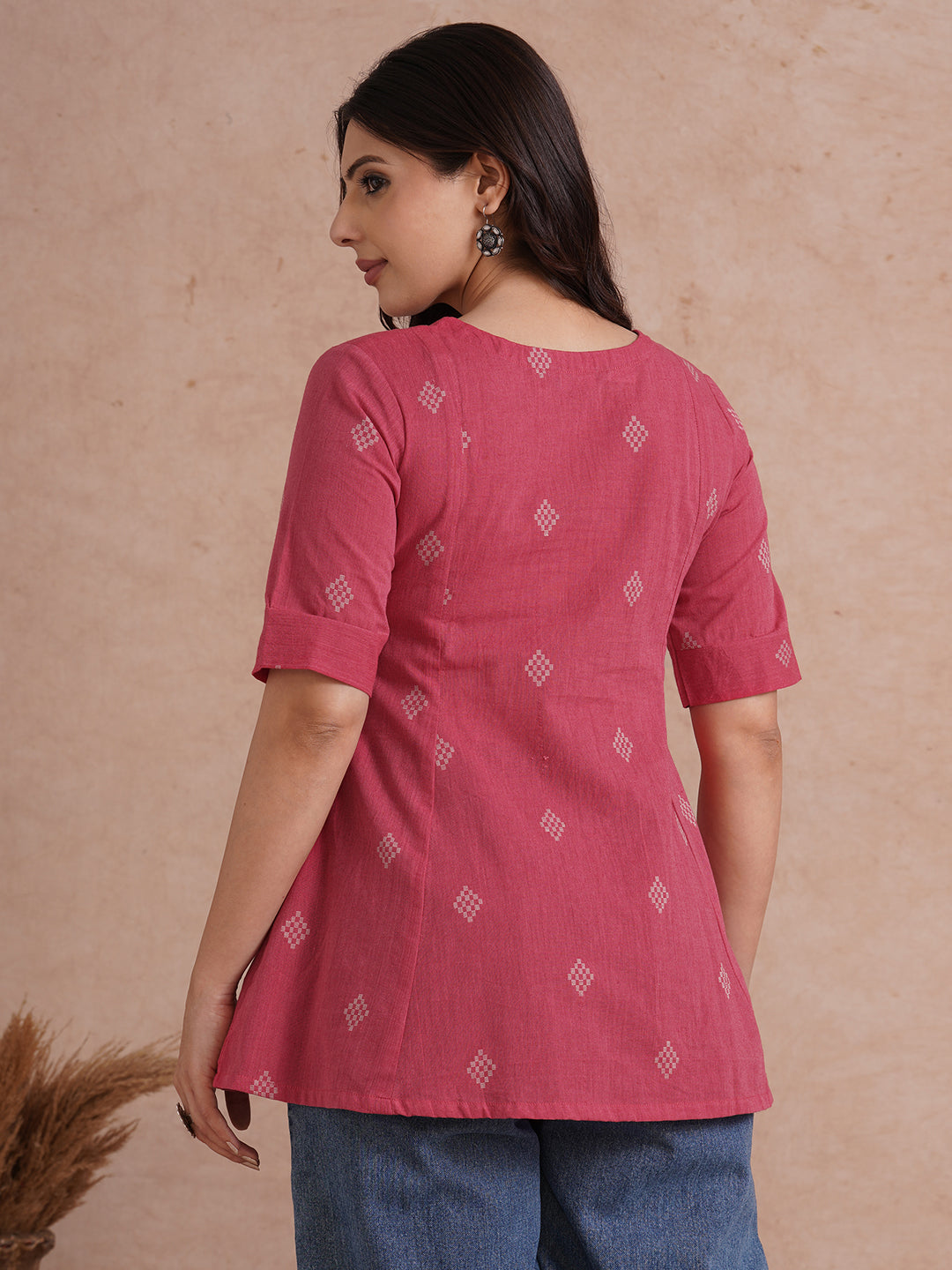 Pleated top with dobby fabric panels and elbow sleeves.