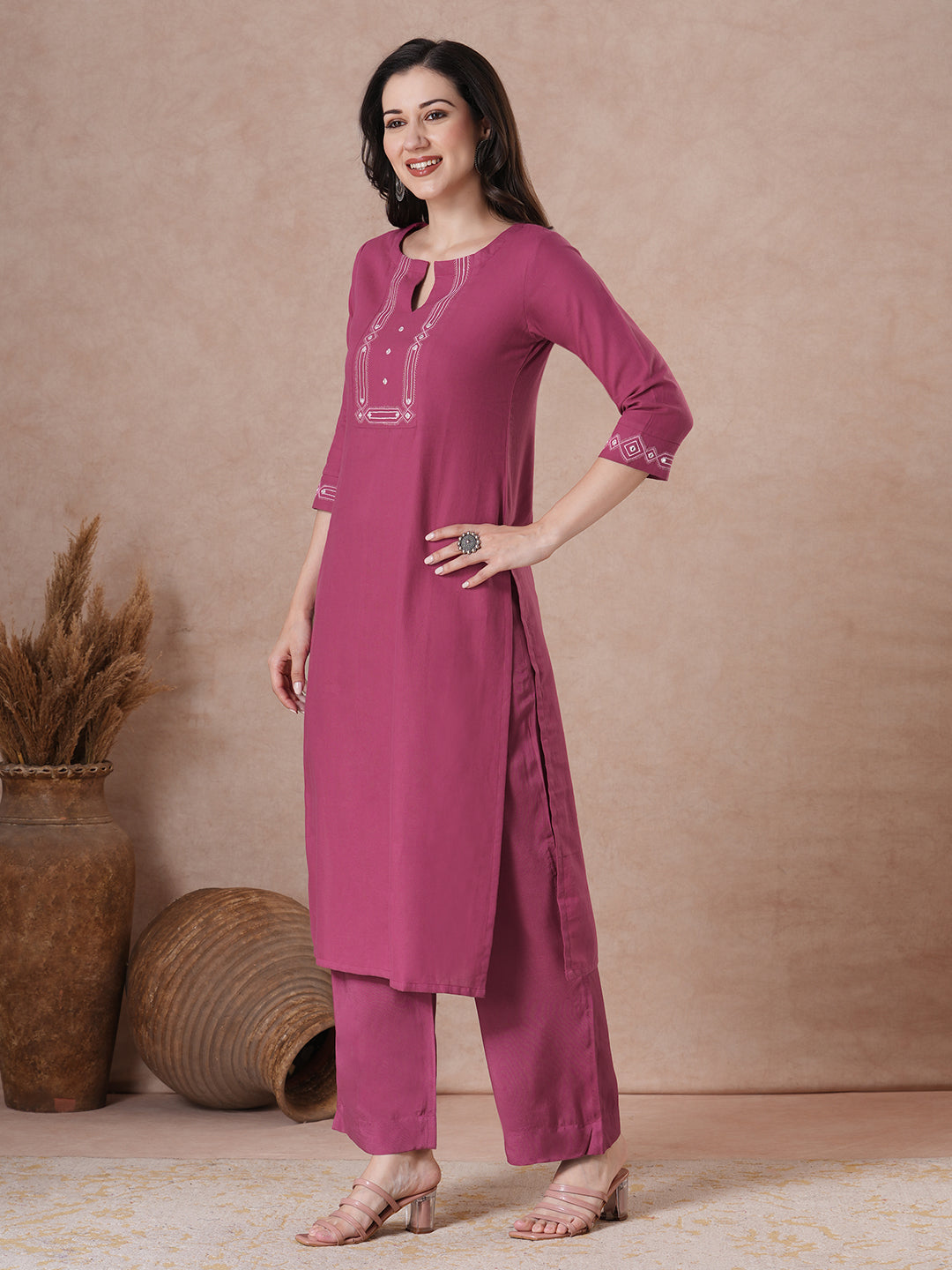 A straight fit kurta with minimal monochromatic embroidery on the neckline.