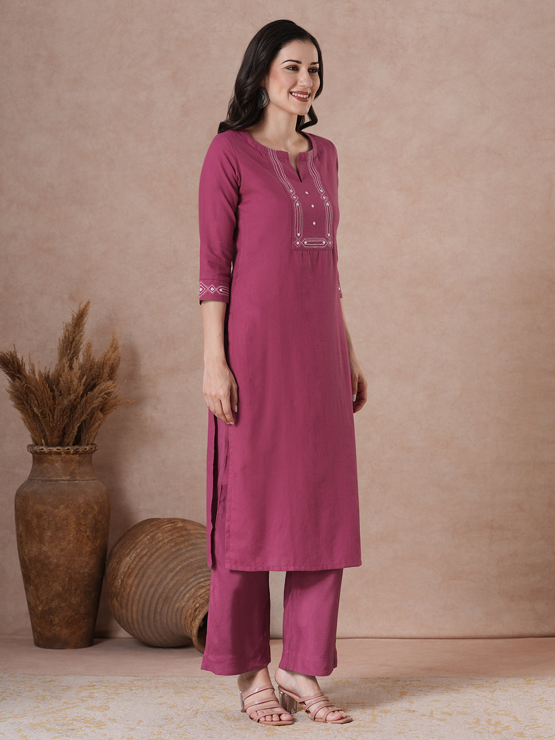 A straight fit kurta with minimal monochromatic embroidery on the neckline.