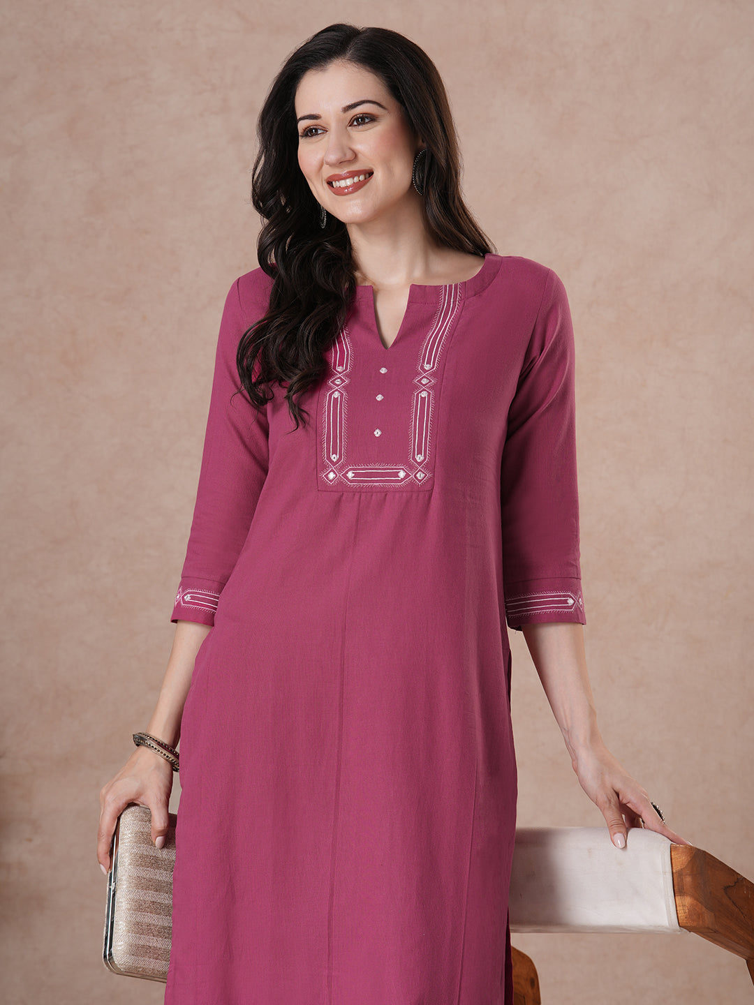 A straight fit kurta with minimal monochromatic embroidery on the neckline.