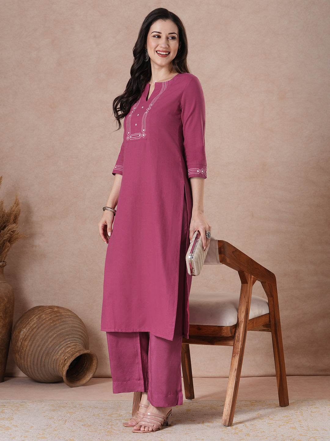 A straight fit kurta with minimal monochromatic embroidery on the neckline.
