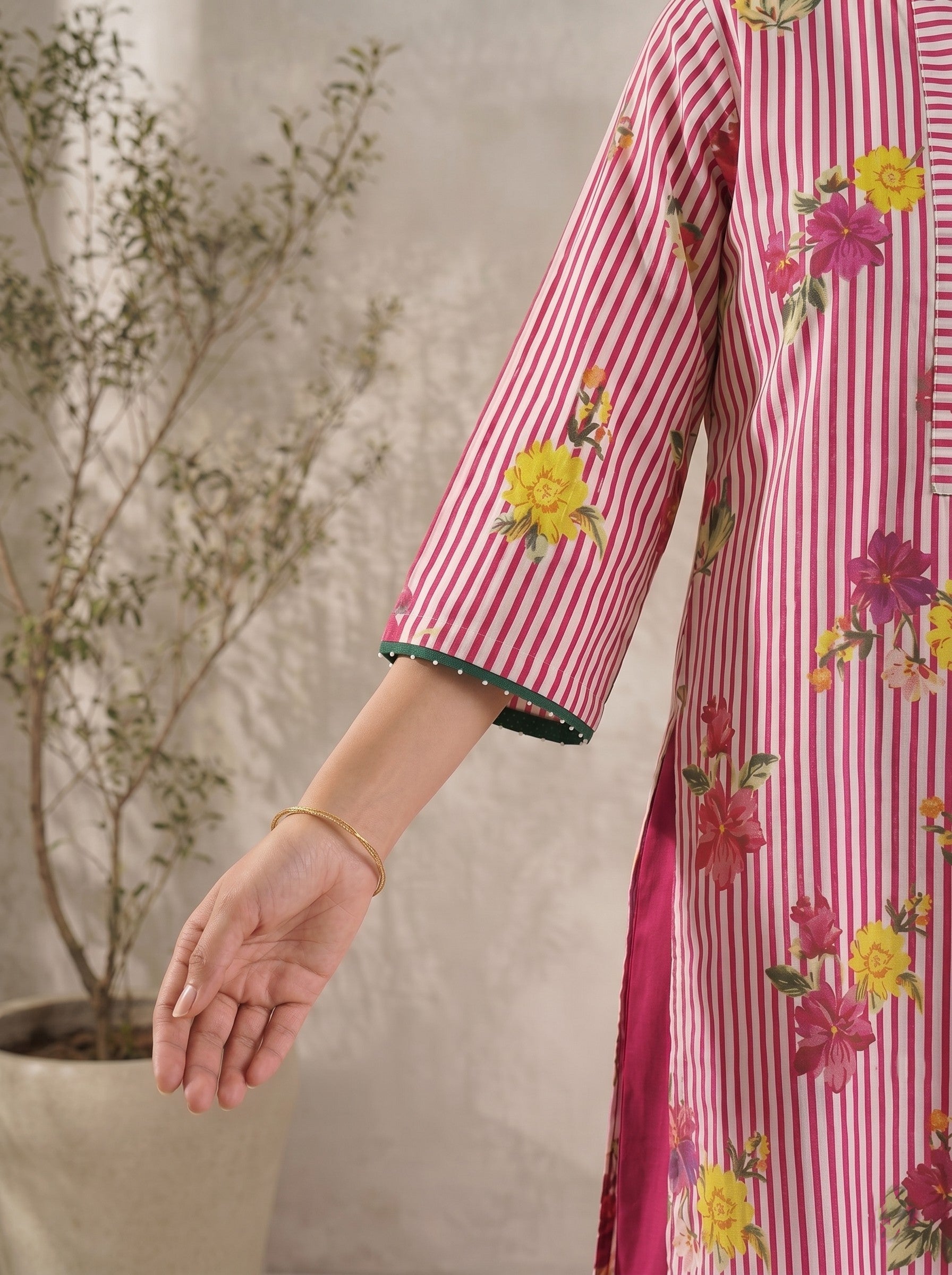 JOYLAND-Printed A-line Cambric kurta with center box pleat, bell sleeves and piping on neck and sleeves with beads.