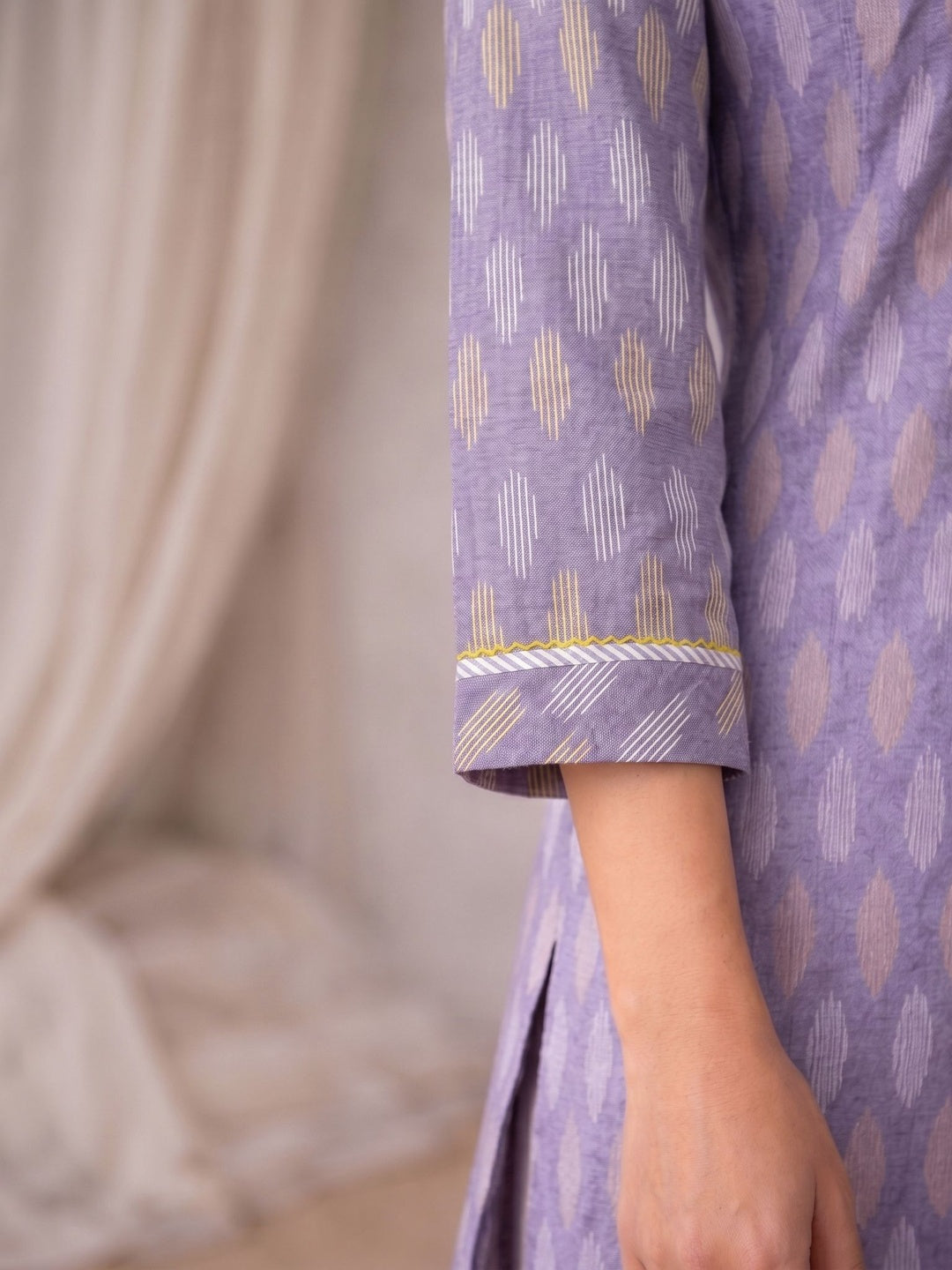 Cotton Ikat fabric straight kurta with woven stripe piping and handwork.