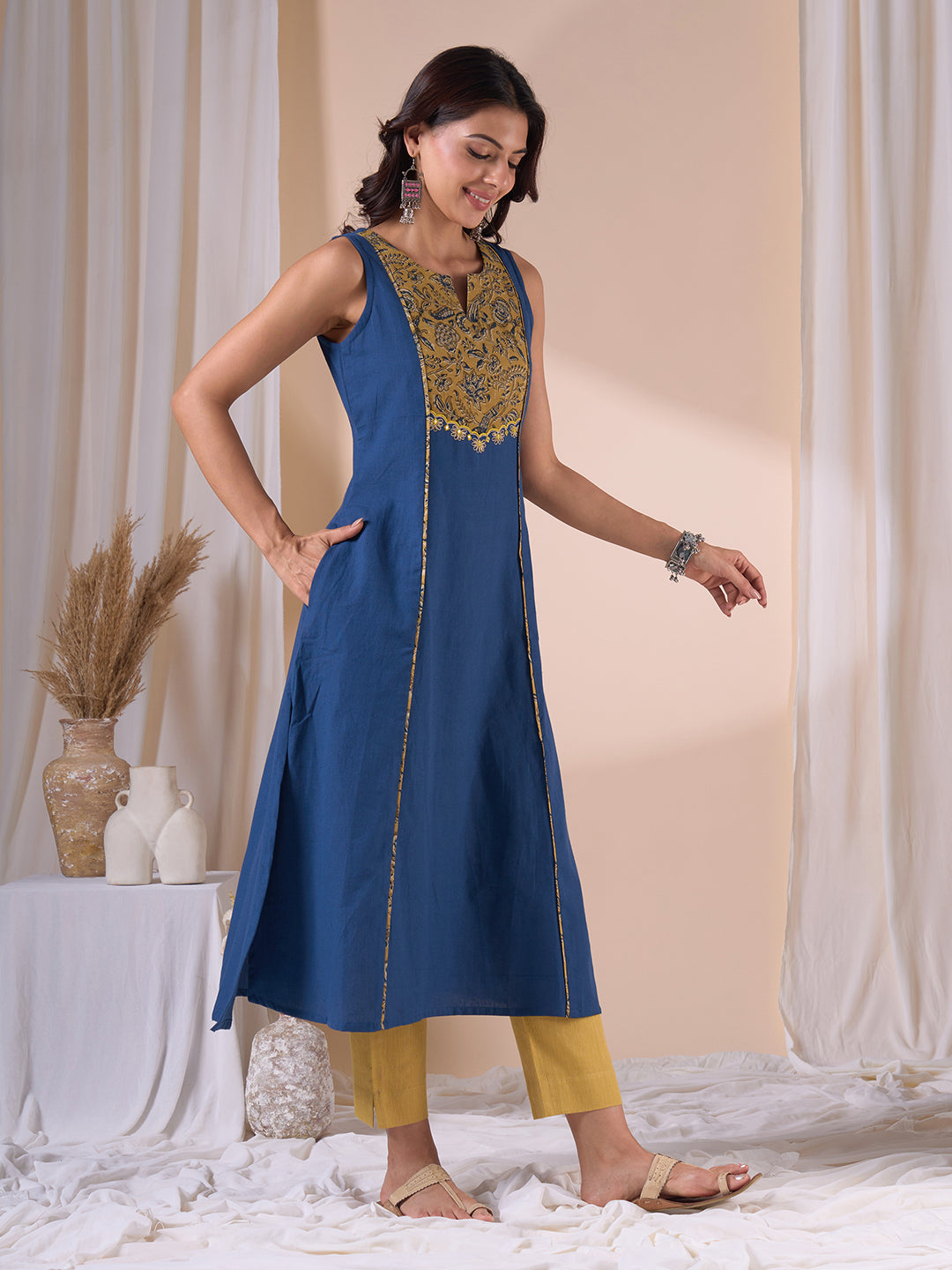 A-Line Sleeveless Kalamkari Cutwork Yoke Cotton Kurta with Contrast Piping.