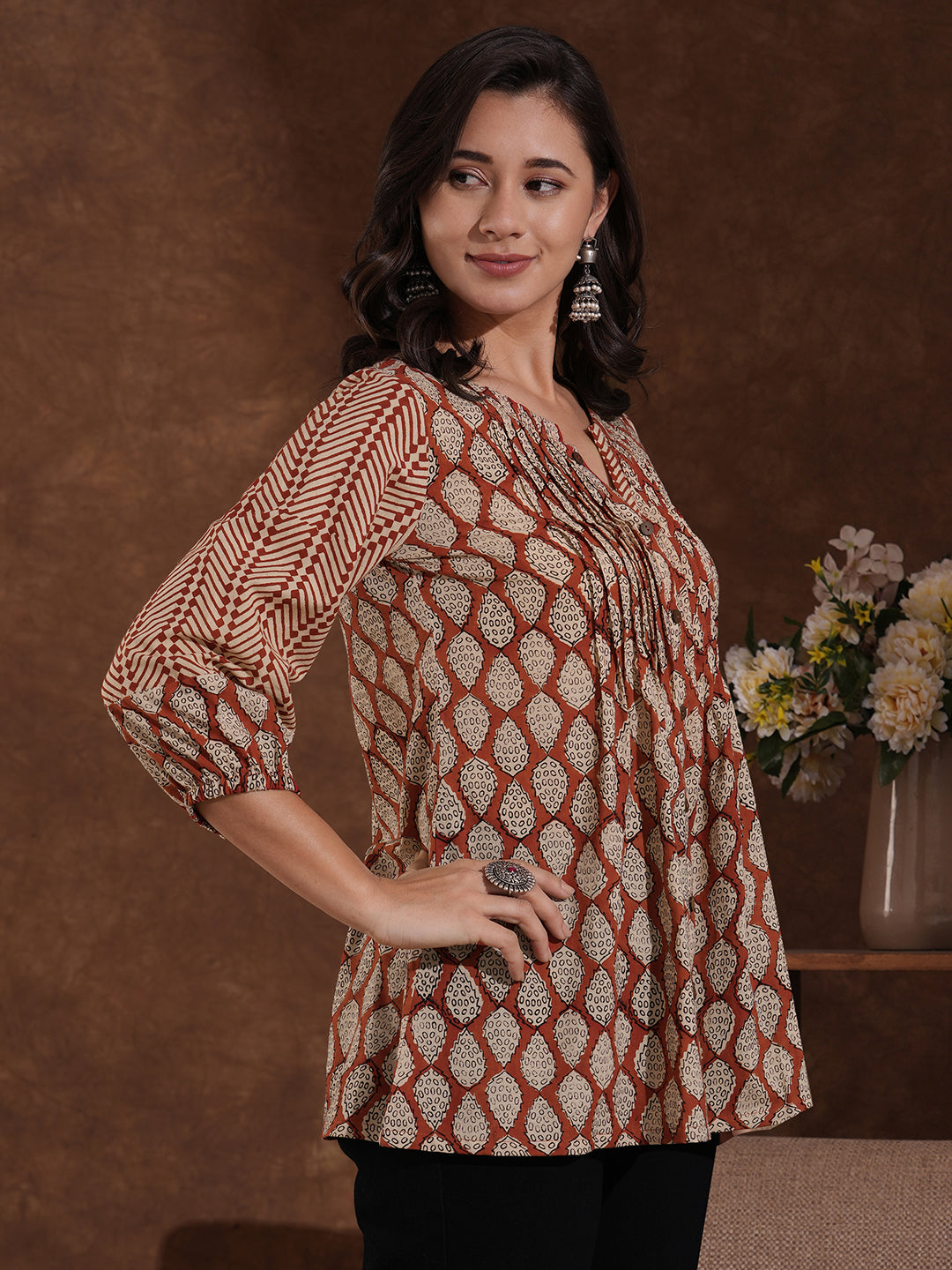 Hand block printed rust tunic with pleating and puff sleeves.