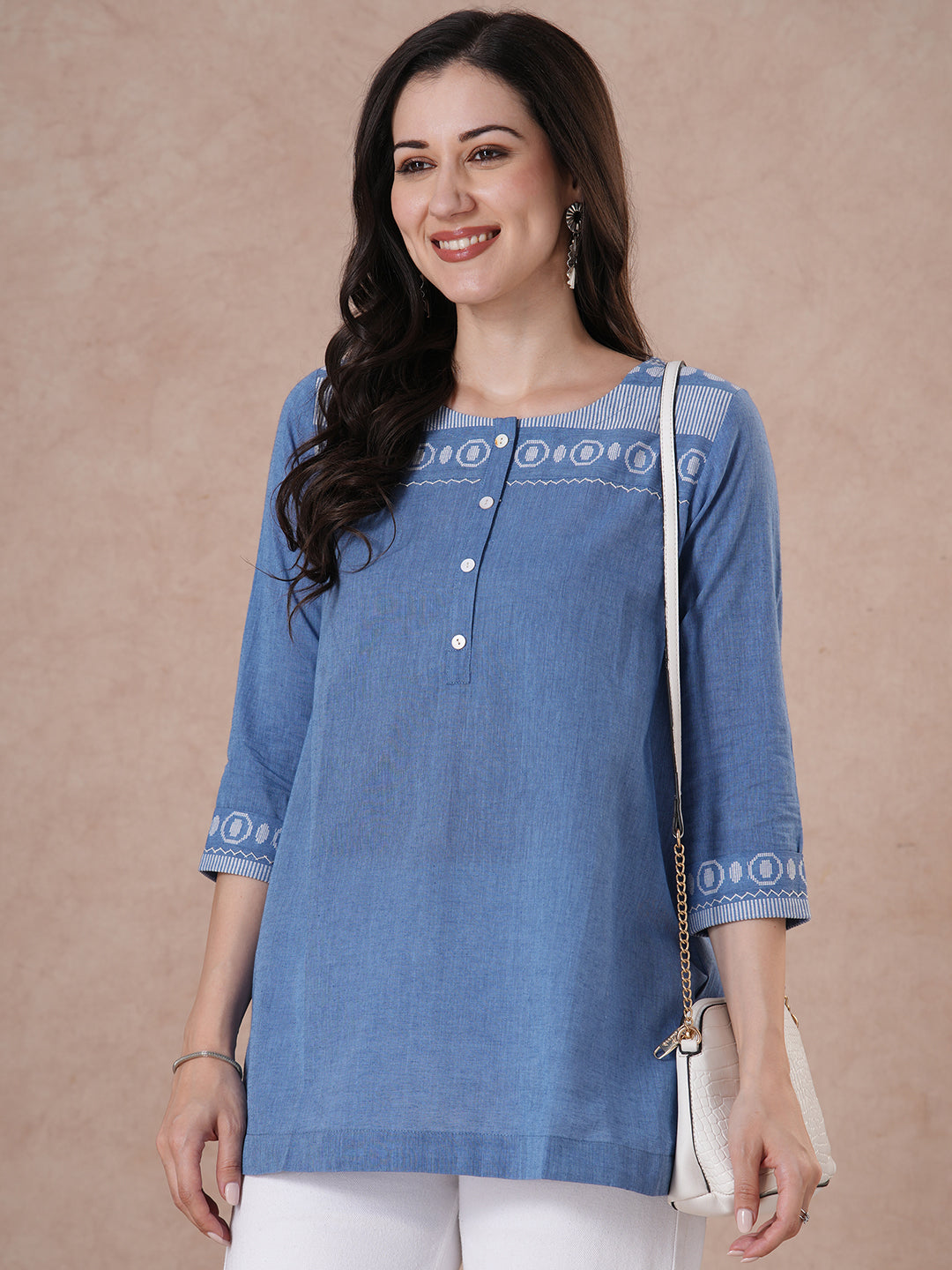 Woven cotton dobby tunic in light pink shade with hand embroidery.